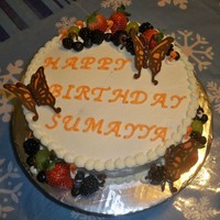 Butterflies And Fruit Buttercake w buttercream frosting and strawberries in the middle. YUMM. Fresh fruits and chocolate butterflies