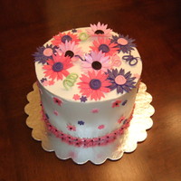 Pink Daisy Cake 8" round with butter cream. Fondant pink & purple daisies.
