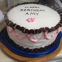 Woman's Birthday Cake A 2-layer chocolate cake that has a whipping cream-fudge filling with almond slices. The cake is covered in Rich's Whip Topping.