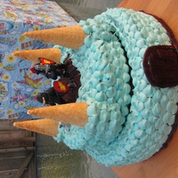 Boy Castle 6th birthday cake made with: buttercream frosting, 3 round cake layers, 4 ice cream cones