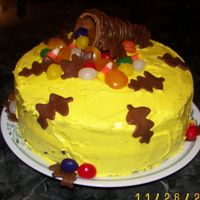 Cornucopia Cake This is a 9" round cake with buttercream frosting. I used an ice cream sugar cone for the basket and different assorted candies. The...