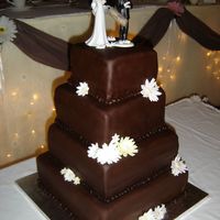 Best Friends Wedding Cake My first attempt at a tier cake. This is made with chocolate fondant and fondant flowers.
