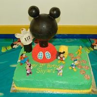 Mickey Mouse Clubhouse I made this cake for my daughter's 1st birthday. The head, ears, neck, and arm are made out of chocolate (hollow). The head was filled...
