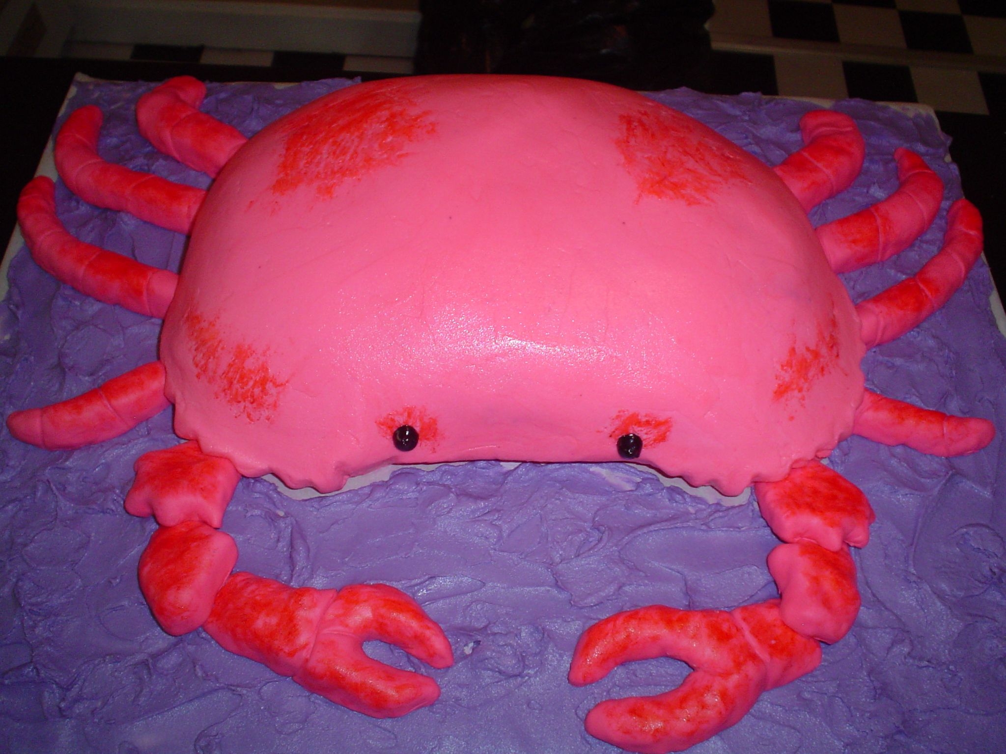 Crab Cake two 9x13 carved cakes, with fondant covered marshmallow legs and pincers. Buttercream crab and water