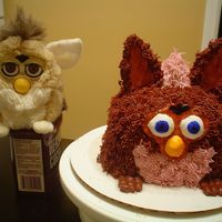 Furby Cake 3-9inch cakes, gumpaste face, accents and ears--chocolate buttercream. Made for bf's birthday who loves furbys!