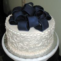 Anniversary Cake This was my first attempt with the scroll design. My bow could have been better.. Fondant bow..the rest is BC.