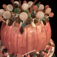 Pumpkin Trick Or Treat pumpkin shaped cake , with butter cream icing painted pumpkin orange , filled with tons of candy,