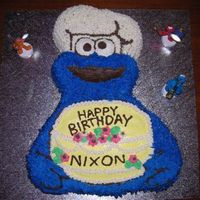 Wilton Cookie Monster Cake With Birthday Cake This was for my son's 2nd Birthday. I also made Sesame Street cupcakes to go with it.Used tip 233 for his fur