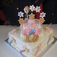 Fairies And Stars! A two tier white chocolate sponge (English) filled with a strawberry jam and vanilla buttercream(English) dressed in a cream coloured...