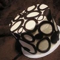 Masculine Ovals This is a version of bananas foster cake...banana cake filled and frosted with a brown sugar maple cinnamon IMB. The ovals are dark...