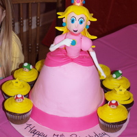 Princess Peach Princess Peach cake with Mario cupcakes.