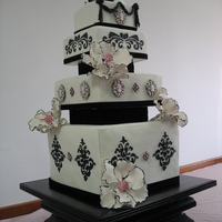 Pink And Black Victorian Wedding All cake except for black stand and black velvet dividers and topper. Brooches and flowers made from gumpaste.