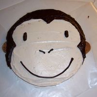 Curious George Monkey This is a quick, simple way to do a cake for a kid that wants a monkey or curious george. 10" round. Used cookies for the ears.