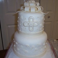 First Communion White Round Tiered All fondant accents with shimmer brushed on. First time doing bow.