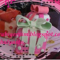 Mini Present Cakes I Made these for my parents.The cakes are red velvet cake and the frosting is speckled cinnamon frosting by Martha Stewart.