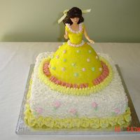 Princess Belle Cake Yellow pound cake for the doll cake, royal icing accents in pink and green. Fondant and buttercream on the doll cake with sparkles....