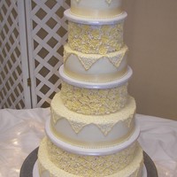 Ivory Tower This is like a cake I did last year, but with 2 additional tiers. Royal roses cover stryofoam cakes separate the ivory iced buttercream...