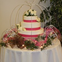 Cinderella's Coach Wedding Cake Three tier buttercream iced smooth with pearl and ribbon accents. Finished with fresh flowers. Cake set up is custom made Cinderella's...