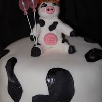 Moo! I did this cake for a friends girlfriend... she really likes cows. I molded the cow out of fondant and also covered the cake in rolled...