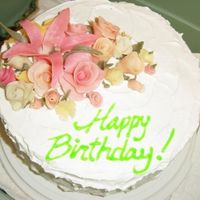 L_3F9Dacb963A546A9D6Dbf85C2573.jpg White cake with raspberry filling and whipped cream topping. Gum paste flowers