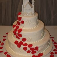 Snowflakes And Rose Petals White cake with strawberry buttercream filling. Satin Ice fondant and gumpaste rose petals. For winter-themed wedding