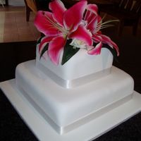 Lillywedd.jpg Square cakes, covered in fondant, flowers are artificial.