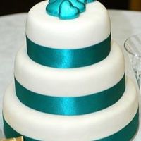 Jade.jpg This was just a plain, simple wedding cake for a lady who wasn't really into the girly, frilly part of getting married. The chocolates...