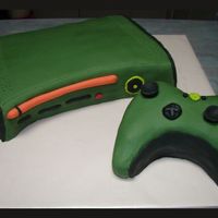 X-Box 360 Halo Edition This is the Halo edition of an x-box 360, just in case you wondered about the green. Just a chocolate mud cake with Fondant icing.
