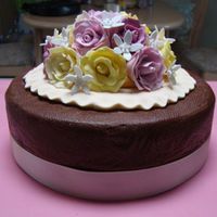 Pink And Yellow Roses Shades of pink and yellow modeling fondant roses (hand made not cutters), with small white flowers (I can't for the life of me...