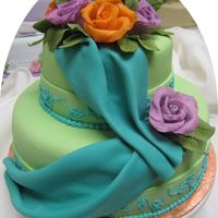 Green & Blue With Roses A practice cake from a class I took. The roses are modeling chocolate. The embroidery work is royal icing. The swags are a combo of gum...