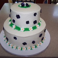 Purple Pleasure reduced sugar lemon cake on top and triple chocolate fudge on the bottom....all buttercream with royal icing flowers