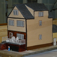 Row House This was a recreation of the anniversary couple's 4 story row house with the little details like mismatched siding and plastic chairs...