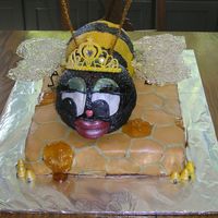 Queen Bee Cake The honeycomb is all individually cut in a hexagon out of fondant, the tiara is royal icing with inset jewels, and the wings are spun sugar...