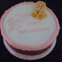 My Very First Cake! this is the first cake I have ever done i know the lettering isn't brill, and the roses are made out of marzipan and the wrong colour...