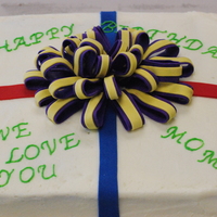 Bday Gift This is a cake I made for a friend at work. It is a carrot cake with cream cheese icing and a fondant ribbon and bow.
