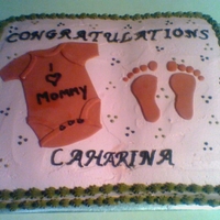 Baby Shower Cake I made this cake for a coworker's baby shower. It's a full sheet cake, all buttercream with fondant onesie and feet prints.