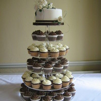 Chocolate And Vanilla Cupcake Tower 7" chocolate orange sponge cutting cake covered in fondant with gumpaste flowers and diamante trim.100 cupcakes in a mix of flavours...