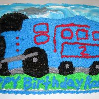 Train Birthday Cake Made this for one of my Grandsons Birthday . He turned 2 years old and he loves anything to do with trains . All buttercream icing .