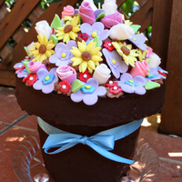 Flower Pot This is a chocolate fudge/Vanilla cake, with raspberry filling, the pot is covered with chocolate ganache, flowers are all fondant.