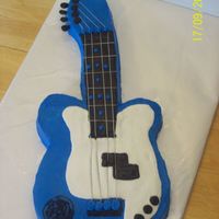 Guitar all buttercream with floral wire for strings. Customer is in a band and it has his logo on it. He loved it!