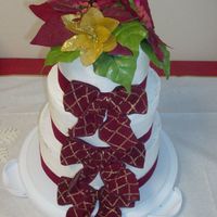 Christmas Wedding Cake 3 tiered FBC. Top layer lemon with chocolate pudding filling; middle tier chocolate fudge with FBC filling; bottom tier vanilla with vailla...