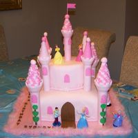Sydney's Castle Cake A castle cake for my daughter's 4th birthday. A 12" square pink WASC filled with bubblegum mousse, covered in white chocolate BC...
