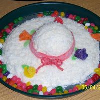 Easter Bonnet Bottom of cake was baked on a pizza pan. Top of bonnet was baked in a glass bowl. Covered in buttercream icing and coconut. Flowers are...