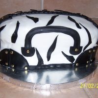 Zebra Purse 4 layers with strawberry cream cheese filling. Buttercream icing coverd with fondant. Done for a friend's birthday that loves purses...