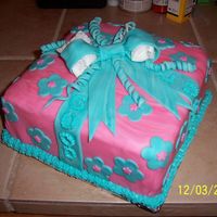 Good Luck 3 layer present cake. Cream cheese and strawberry filling. Has buttercream icing under the fondant. Fondant bow and accent pieces.