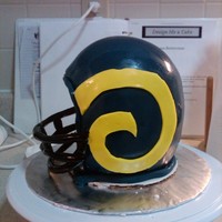 Ram's Football Helmet Birthday cake for my brother in law. Carrot Cake with cream cheese icing and fondant. Not too bad for my first helmet cake but learned a...