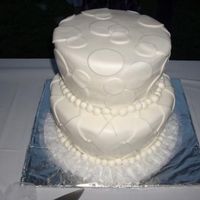 Geometrical Cake unique cake. the side were tapered in at bottom. The top decorated with circles and bottom with the diamond pattern. All fondant