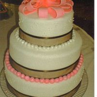 First Fondant Wedding Cake Pink bow, fondant balls with lustre dust, brown ribbon bride picked out.French vanilla cake with raspberry filling.