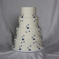 Swags, Flowers And Scrolls 6" 8" 10" 12" Rounds iced in fondant with fondant flowers and royal icing scrolls