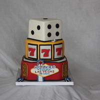 Married In Fabulous Las Vegas 5" square top tier, 8" round middle tier, 9" square bottom tier with corners cut. Iced in fondant with sugar decorations.